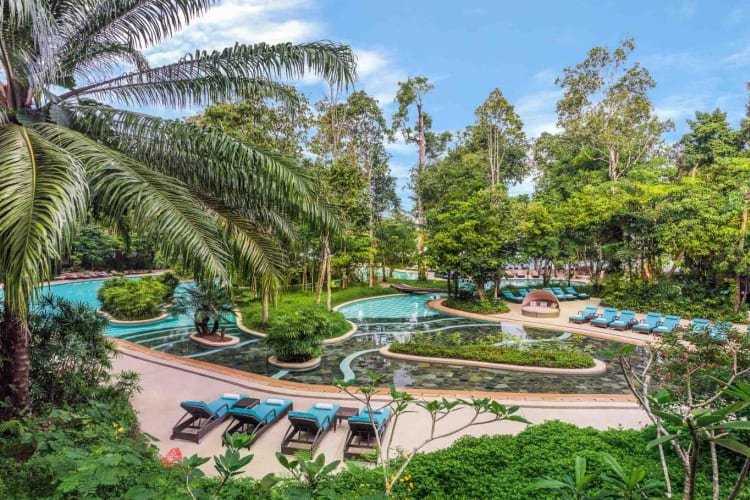 Landscaped swimming pool with sun beds